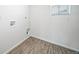 Laundry room with wood-look flooring and built-in shelving at 16142 E 111Th Dr, Commerce City, CO 80022