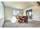 Bright dining area with backyard access, a square table, and tall chairs with dark upholstery at 7353 S Queensburg St, Aurora, CO 80016