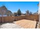 Spacious backyard featuring a wooden deck, perfect for outdoor gatherings and activities at 14936 E Arizona Pl, Aurora, CO 80012