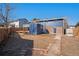 Expansive backyard featuring a shed, deck, and a mix of gravel and grassy areas at 14936 E Arizona Pl, Aurora, CO 80012