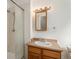 Bathroom featuring a shower, a vanity with a mirror, and neutral-toned tiling at 14936 E Arizona Pl, Aurora, CO 80012