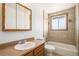 Bathroom featuring a shower-tub combo, a vanity with a large mirror, and neutral tile at 14936 E Arizona Pl, Aurora, CO 80012
