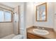 Well-lit bathroom showcasing a tiled shower, vanity, and neutral color palette at 14936 E Arizona Pl, Aurora, CO 80012