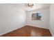 Inviting bedroom with hardwood floors, a ceiling fan, and a bright window at 14936 E Arizona Pl, Aurora, CO 80012