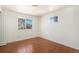 Sunny bedroom featuring hardwood floors and large windows offering outdoor views at 14936 E Arizona Pl, Aurora, CO 80012