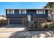 Charming two-story home with a well-maintained lawn and a classic brick and siding facade, creating a welcoming curb appeal at 14936 E Arizona Pl, Aurora, CO 80012