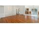 Open-concept living space with hardwood floors flowing into the dining area, with stairs nearby and bright, neutral walls at 14936 E Arizona Pl, Aurora, CO 80012