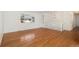 Bright living room featuring gleaming hardwood floors, white walls, and a large window offering plenty of natural light at 14936 E Arizona Pl, Aurora, CO 80012