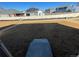 Unfinished backyard with bare dirt, wood fence, and steps leading down from the house at 22057 E 39Th Pl, Aurora, CO 80019