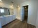 Bathroom with double vanity, walk-in shower, and doorway to walk-in closet at 22057 E 39Th Pl, Aurora, CO 80019
