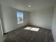 Bright bedroom featuring neutral carpeting and a window providing natural light at 22057 E 39Th Pl, Aurora, CO 80019