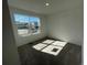 Bright bedroom featuring a large window offering plenty of natural light and neutral carpet at 22057 E 39Th Pl, Aurora, CO 80019