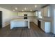 Modern kitchen features white cabinets, stainless steel appliances, and a spacious center island at 22057 E 39Th Pl, Aurora, CO 80019