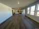 Expansive open-concept living space featuring hardwood floors and ample natural light, adjacent to kitchen at 22057 E 39Th Pl, Aurora, CO 80019