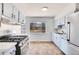 Bright kitchen with white cabinets, tile floor, modern appliances, and a view of the yard at 435 S 42Nd St, Boulder, CO 80305