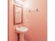 Charming half bathroom features a pedestal sink, mirror, and decorative lighting at 70 W 6Th Ave # 109, Denver, CO 80204