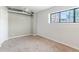 Bright bedroom with natural light from a large window and carpeted floors at 70 W 6Th Ave # 109, Denver, CO 80204