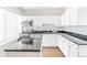 Modern kitchen with white cabinets and granite countertops at 70 W 6Th Ave # 109, Denver, CO 80204