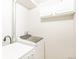 Well-lit laundry room with modern washer and dryer at 70 W 6Th Ave # 109, Denver, CO 80204