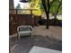 Backyard area with gravel groundcover, stone pavers, privacy fencing, and a seating bench at 995 W Peakview Cir, Littleton, CO 80120