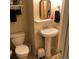 Classic bathroom featuring a pedestal sink, toilet, and neutral color scheme at 995 W Peakview Cir, Littleton, CO 80120