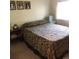 Cozy bedroom featuring a floral comforter, side table, and decorative pictures at 995 W Peakview Cir, Littleton, CO 80120