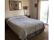 Bright bedroom with a queen bed and sliding glass doors to the patio at 995 W Peakview Cir, Littleton, CO 80120