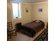 Small bedroom features a window, neutral walls, and a decorative rug at 995 W Peakview Cir, Littleton, CO 80120