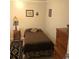 Modest bedroom featuring a single bed, lamp, and decorative carpet at 995 W Peakview Cir, Littleton, CO 80120