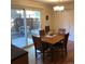 Cozy dining area featuring a wooden table set, hardwood floors, and a sliding glass door to the outdoor area at 995 W Peakview Cir, Littleton, CO 80120