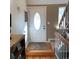 Welcoming entryway featuring a wood floor, decorative front door, and staircase to the second floor at 995 W Peakview Cir, Littleton, CO 80120