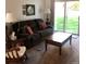 Comfortable living room with a plush sofa, rocking chair, coffee table, and access to the outdoor patio at 995 W Peakview Cir, Littleton, CO 80120