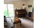 Inviting living room featuring a piano, fireplace, and sliding glass doors to the backyard at 995 W Peakview Cir, Littleton, CO 80120