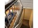 Carpeted staircase with white railing leads to the upper and lower levels at 995 W Peakview Cir, Littleton, CO 80120
