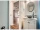 Stylish bathroom featuring a vessel sink and vanity, modern fixtures, and an open doorway at 9139 W 50Th Ln # 204, Arvada, CO 80002