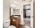 This bathroom features a granite countertop, modern light fixtures, and a view into the bedroom at 9139 W 50Th Ln # 204, Arvada, CO 80002