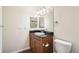 Bathroom features wood cabinet vanity with granite countertops, decorative lighting, and neutral color palette at 9139 W 50Th Ln # 204, Arvada, CO 80002