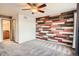 This bedroom features wood accent wall, ceiling fan, and doorway to the bathroom at 9139 W 50Th Ln # 204, Arvada, CO 80002