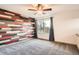 This bedroom features wood accent wall and a neutral carpet at 9139 W 50Th Ln # 204, Arvada, CO 80002