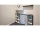 Walk-in closet with built-in white shelving with turquoise totes for organization and storage of personal items at 9139 W 50Th Ln # 204, Arvada, CO 80002