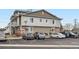 Exterior of tan and brown apartment building with multiple cars in the parking lot at 9139 W 50Th Ln # 204, Arvada, CO 80002