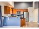 This kitchen features wood cabinets, stainless steel appliances, and a breakfast bar perfect for casual dining at 9139 W 50Th Ln # 204, Arvada, CO 80002