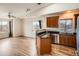 Open kitchen and living space with stainless appliances, granite countertops, and wood flooring at 9139 W 50Th Ln # 204, Arvada, CO 80002