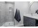 Modern bathroom with glass shower, gray vanity and elegant gray towels at 37 Wagner Cir, Boulder, CO 80304