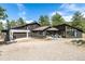 View of home with a three-car garage, a balcony, and a blue stone patio at 37 Wagner Cir, Boulder, CO 80304
