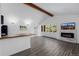 Open living room with fireplace, wood beam and large windows showcasing the view at 37 Wagner Cir, Boulder, CO 80304
