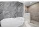 Bright bathroom with large soaking tub, glass shower and gray and tan tile at 37 Wagner Cir, Boulder, CO 80304