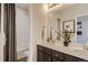 Bright bathroom with double sinks, a large mirror, and a separate shower/tub area, offering convenience and comfort at 1320 Loraine N Cir, Lafayette, CO 80026