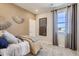 Cozy bedroom with neutral tones, decorative wall art, and a large window, perfect for a restful and stylish retreat at 1320 Loraine N Cir, Lafayette, CO 80026