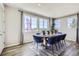 Chic dining room featuring a modern table set, large windows, and neutral tones for a stylish meal space at 1320 Loraine N Cir, Lafayette, CO 80026